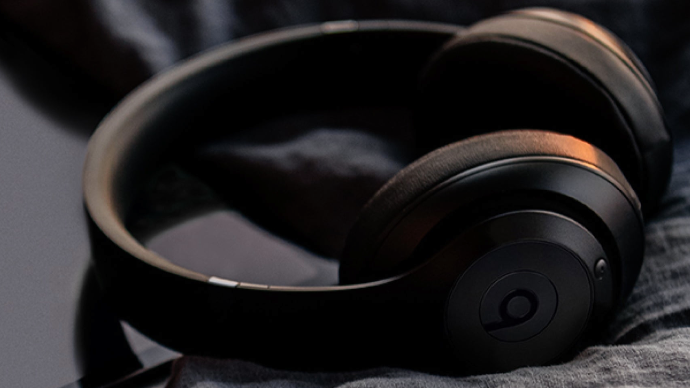 Headphones on top of a piece of fabric in the sunset.