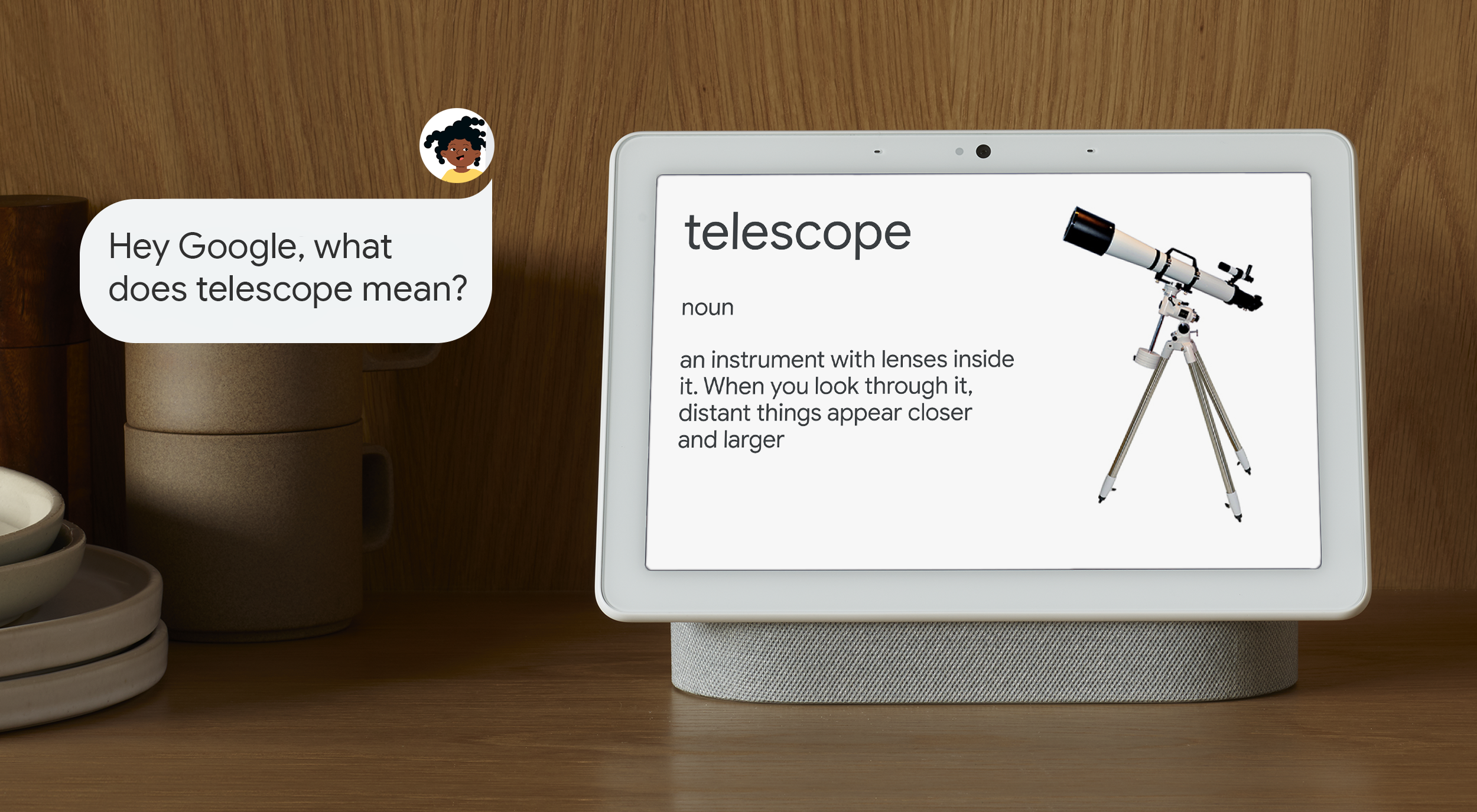 A Google smart screen device sits on a wooden table. On the screen is a kid-friendly definition of a telescope, which reads, 