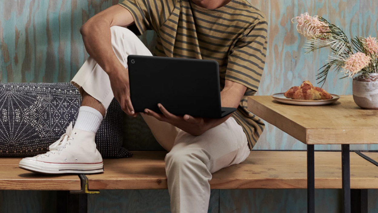 Person holding a Google Pixelbook Go Chromebook. 