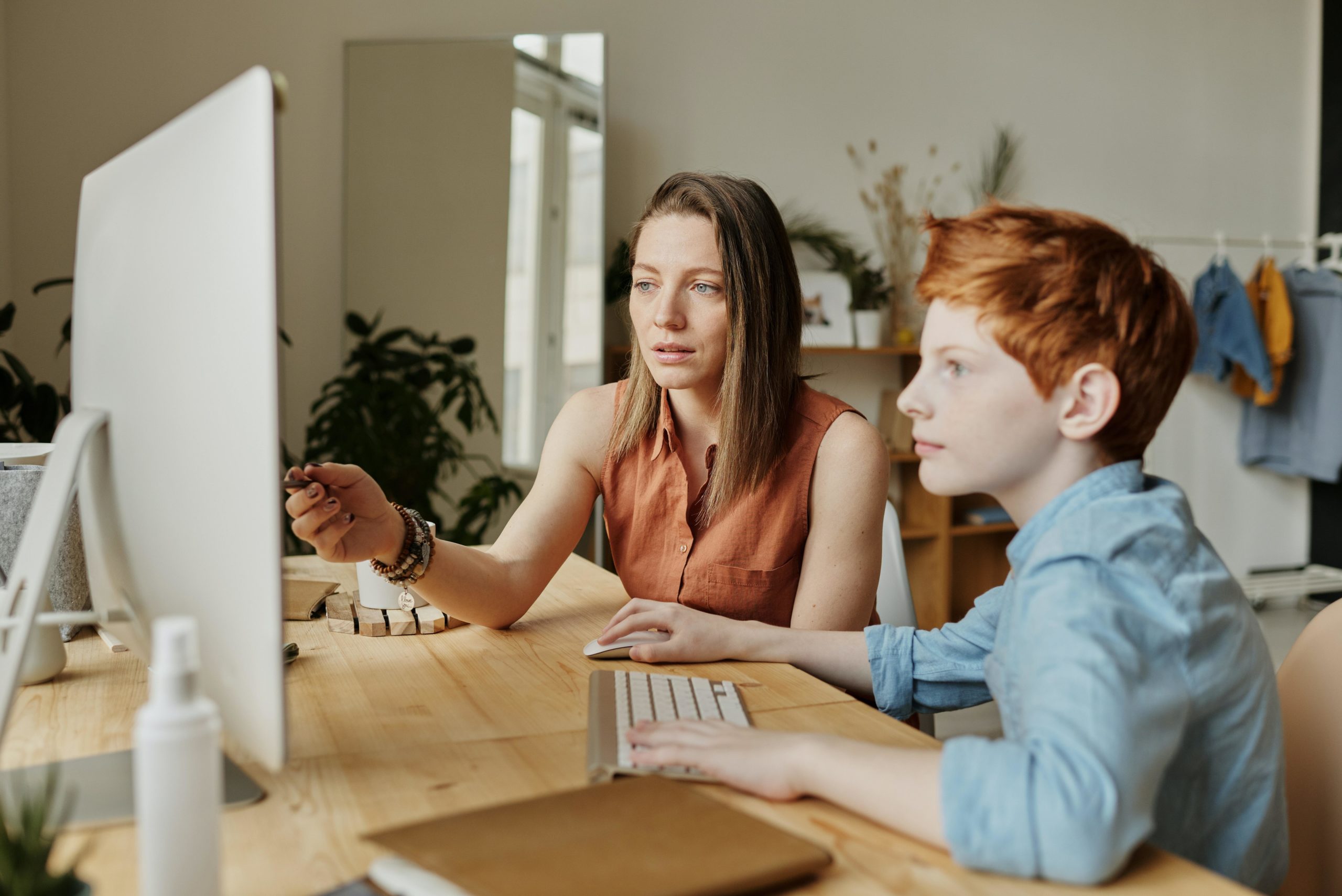 Woman and child looking at PC screen