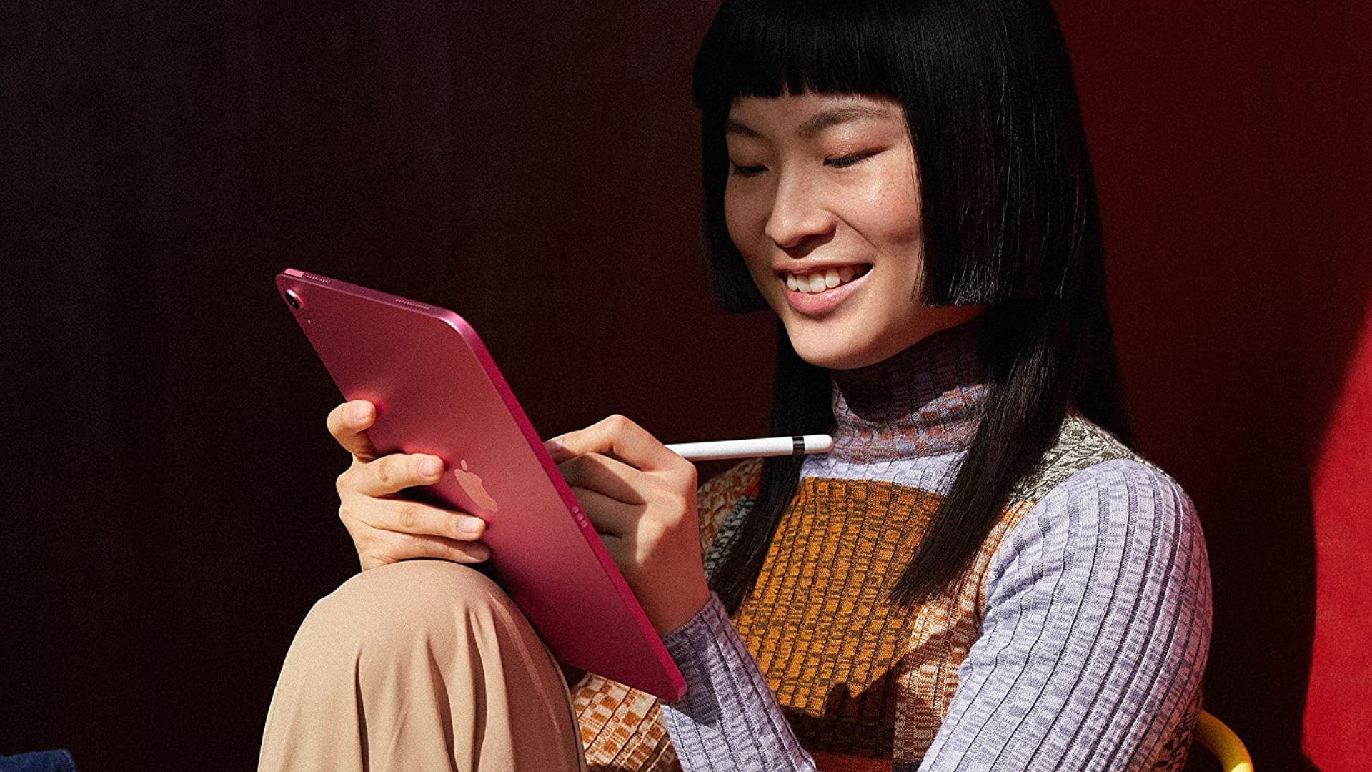 Woman using a red iPad Pro