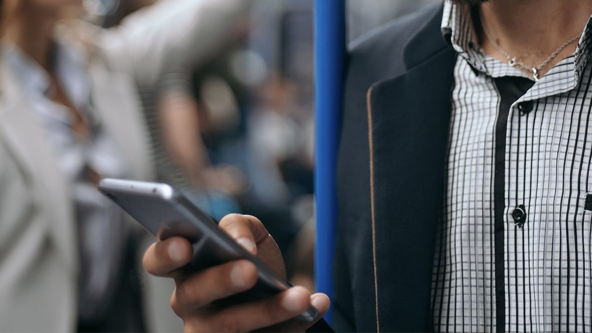 Person on their phone on a train.