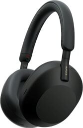 A pair of black headphones lying in an upright position
