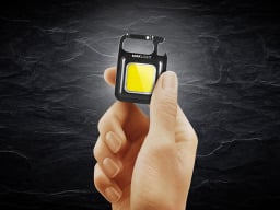 Person holding the 8-in-1 MaxLight Mini Super Bright Utility Flashlight.