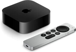 A black media streaming player with a silver remote from the company Apple