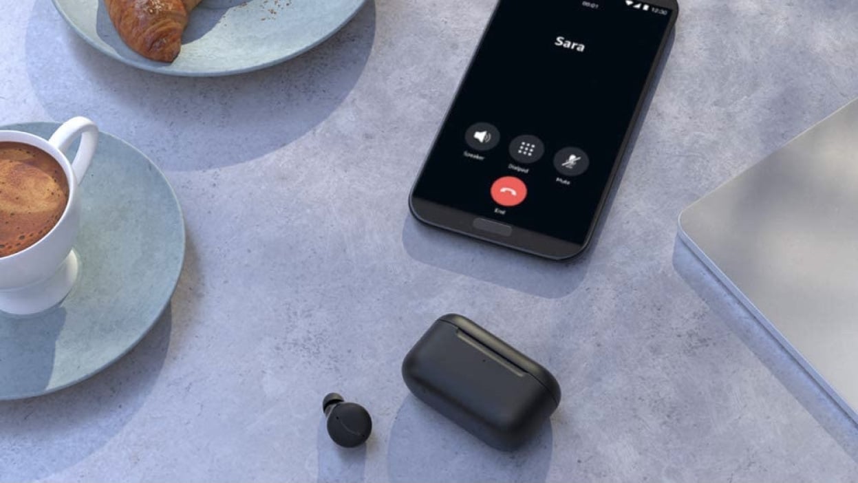 Amazon Echo Buds with smartphone on kitchen table