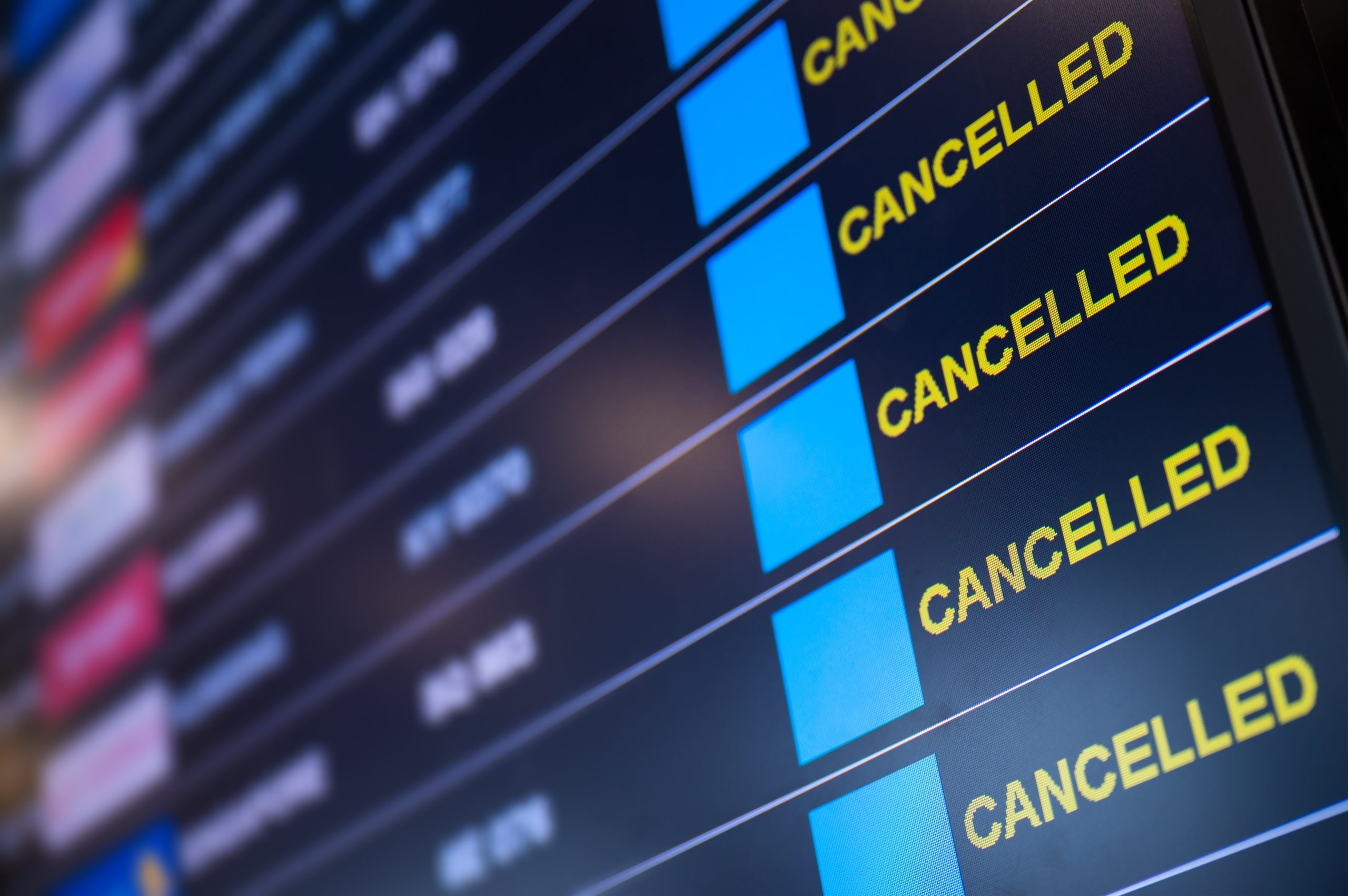 A board shows canceled flights at an airport