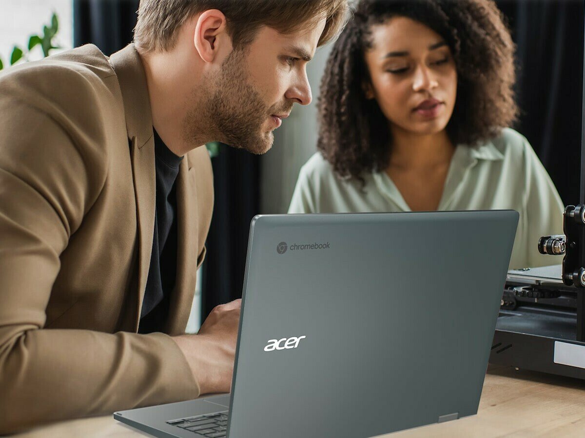 Man and woman sitting in front of gray Acer Spin 714 Chromebook