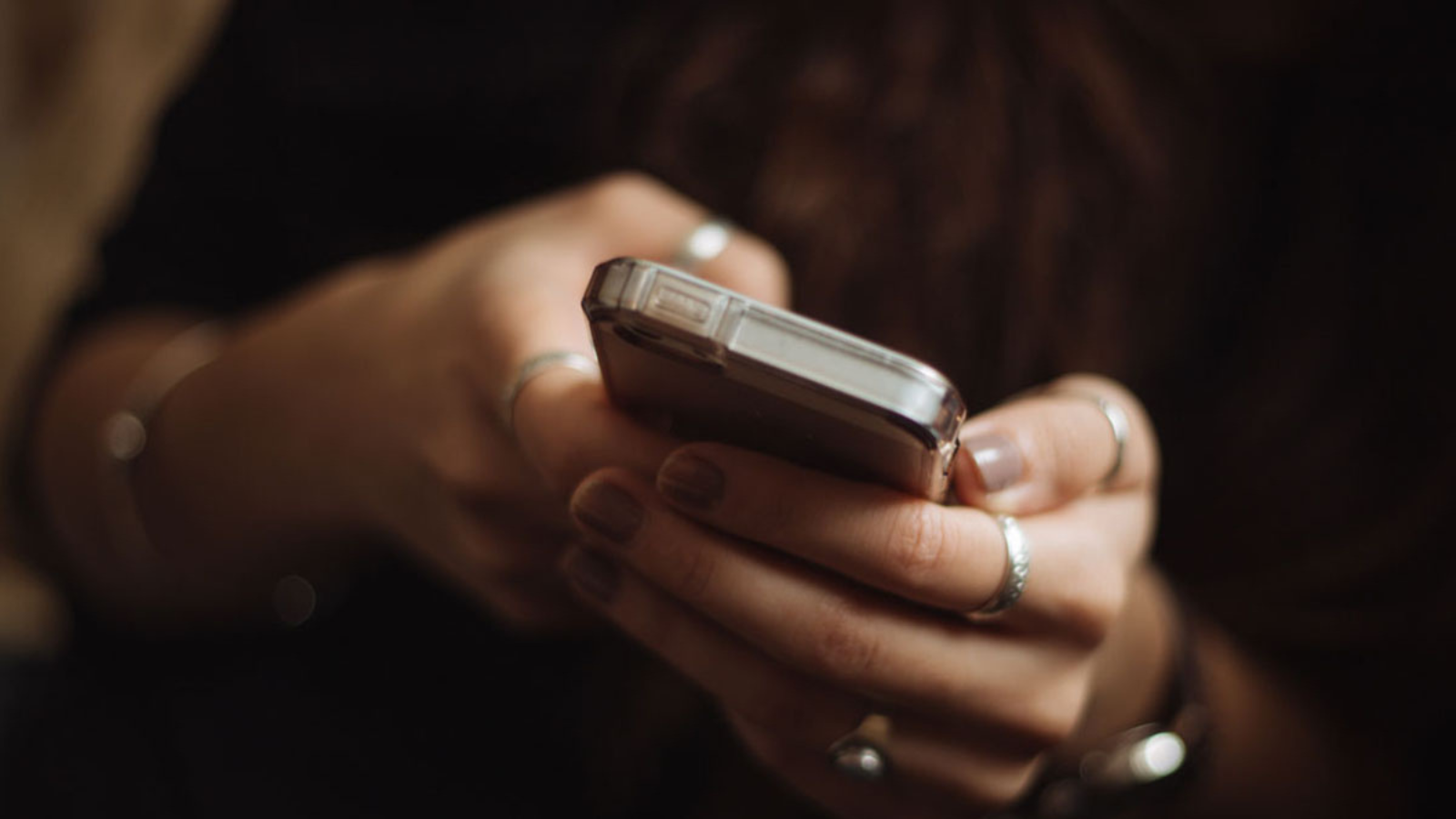 person's hands holding phone