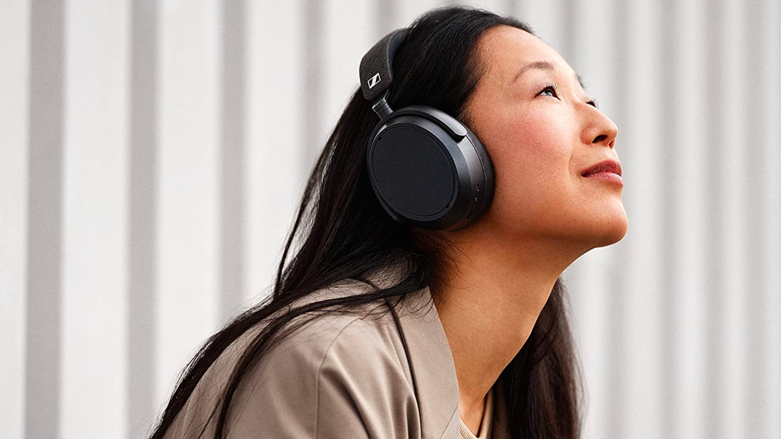 Woman wearing Sennheiser Momentum 4 Wireless Headphones