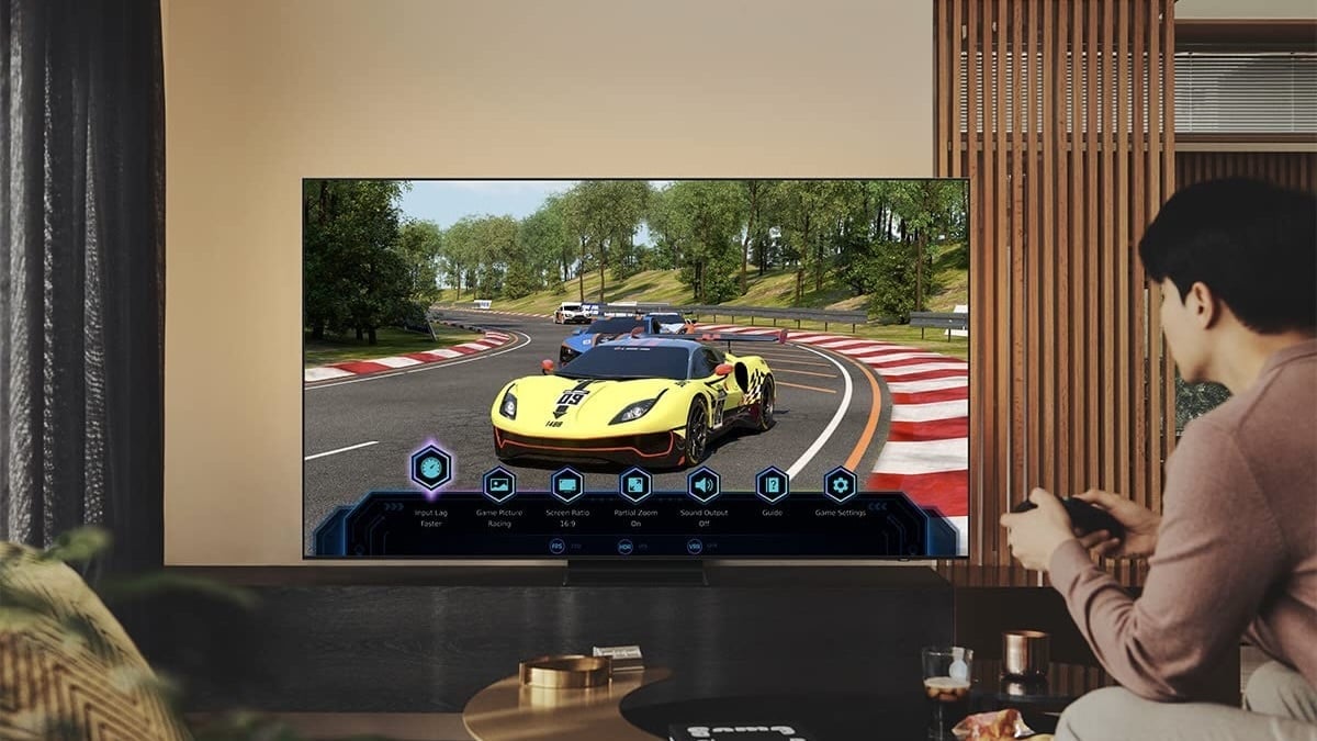 person playing car racing game on tv in living room