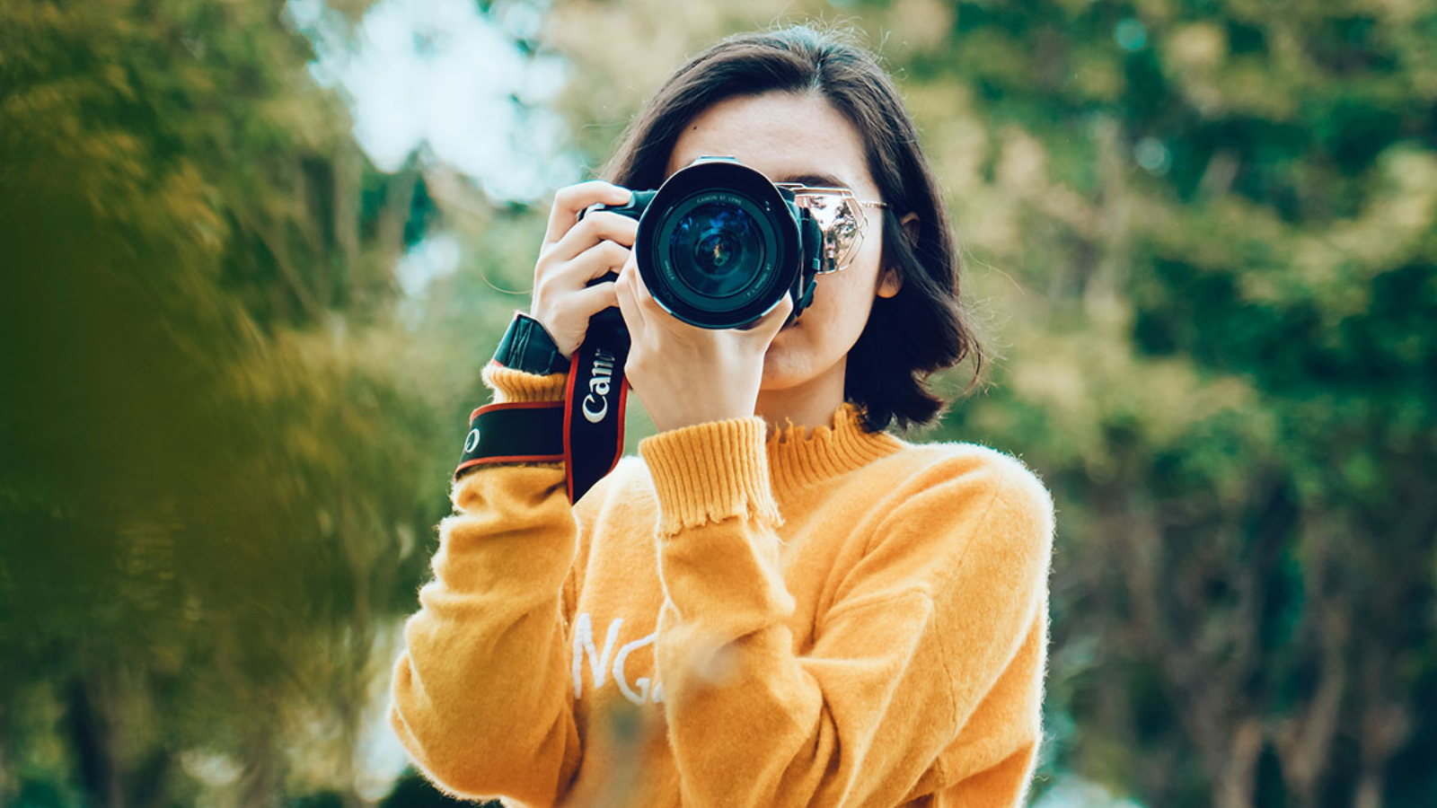 woman snapping a photo with canon camera