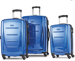 Three piece blue luggage set against a white background