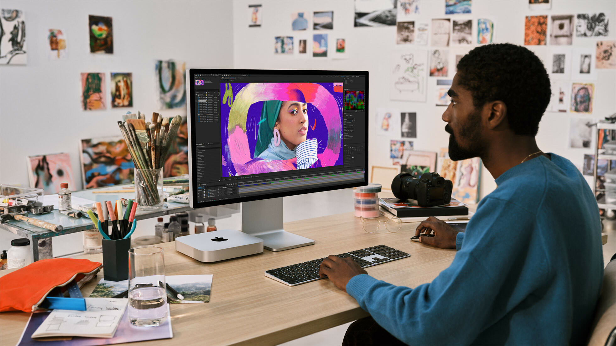 person sitting at desk working on mac mini desktop