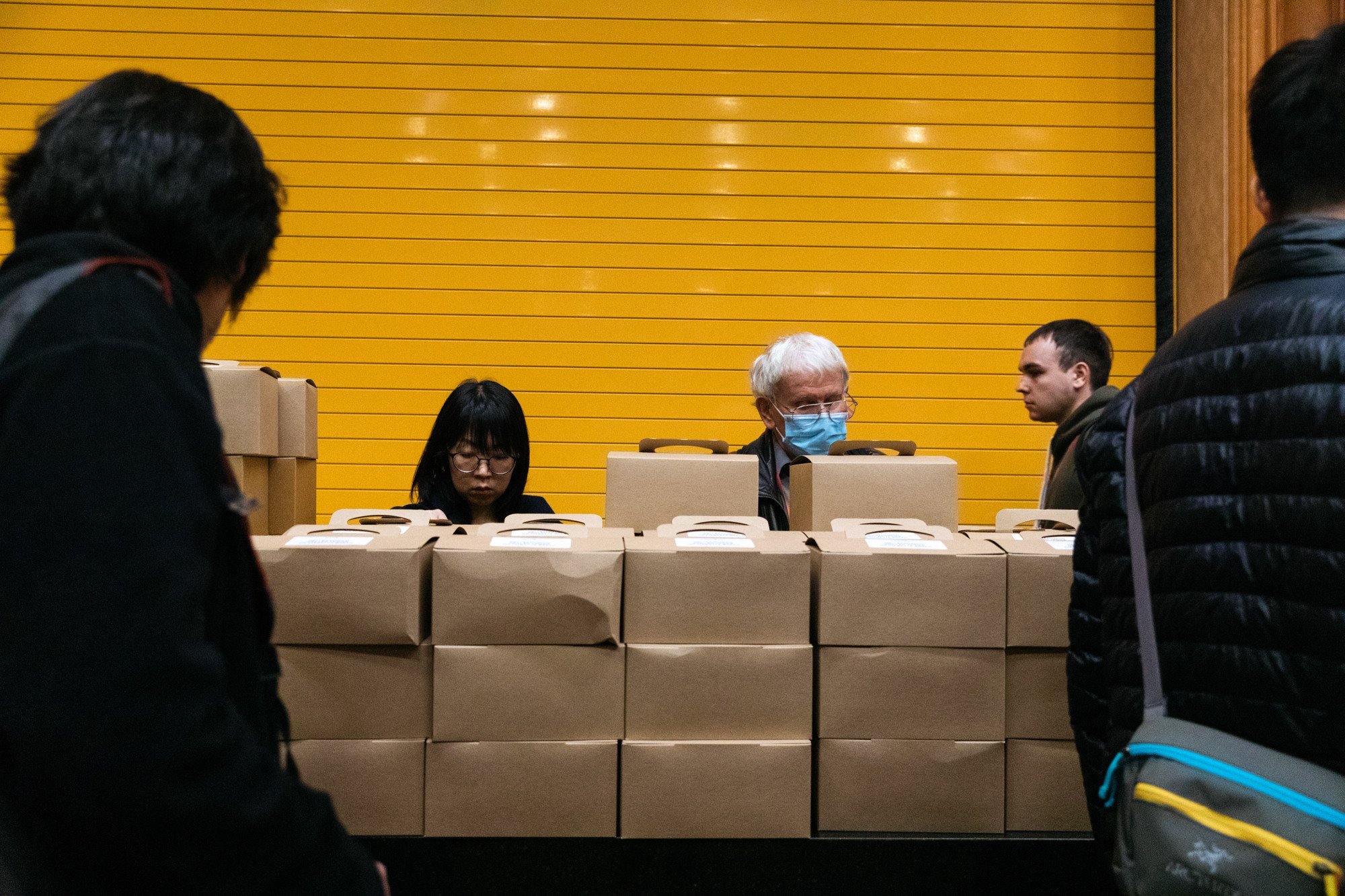 People surrounding box lunches