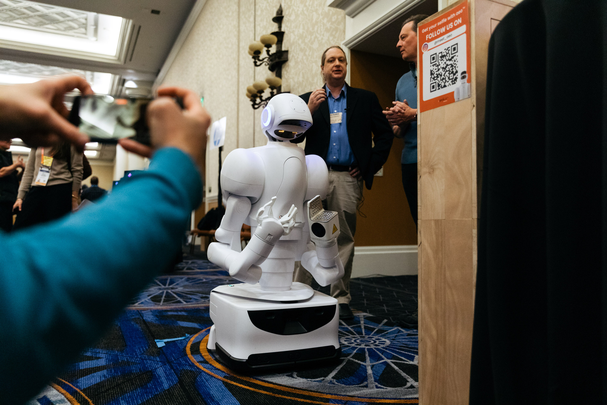 robot on wheels moving through crowd