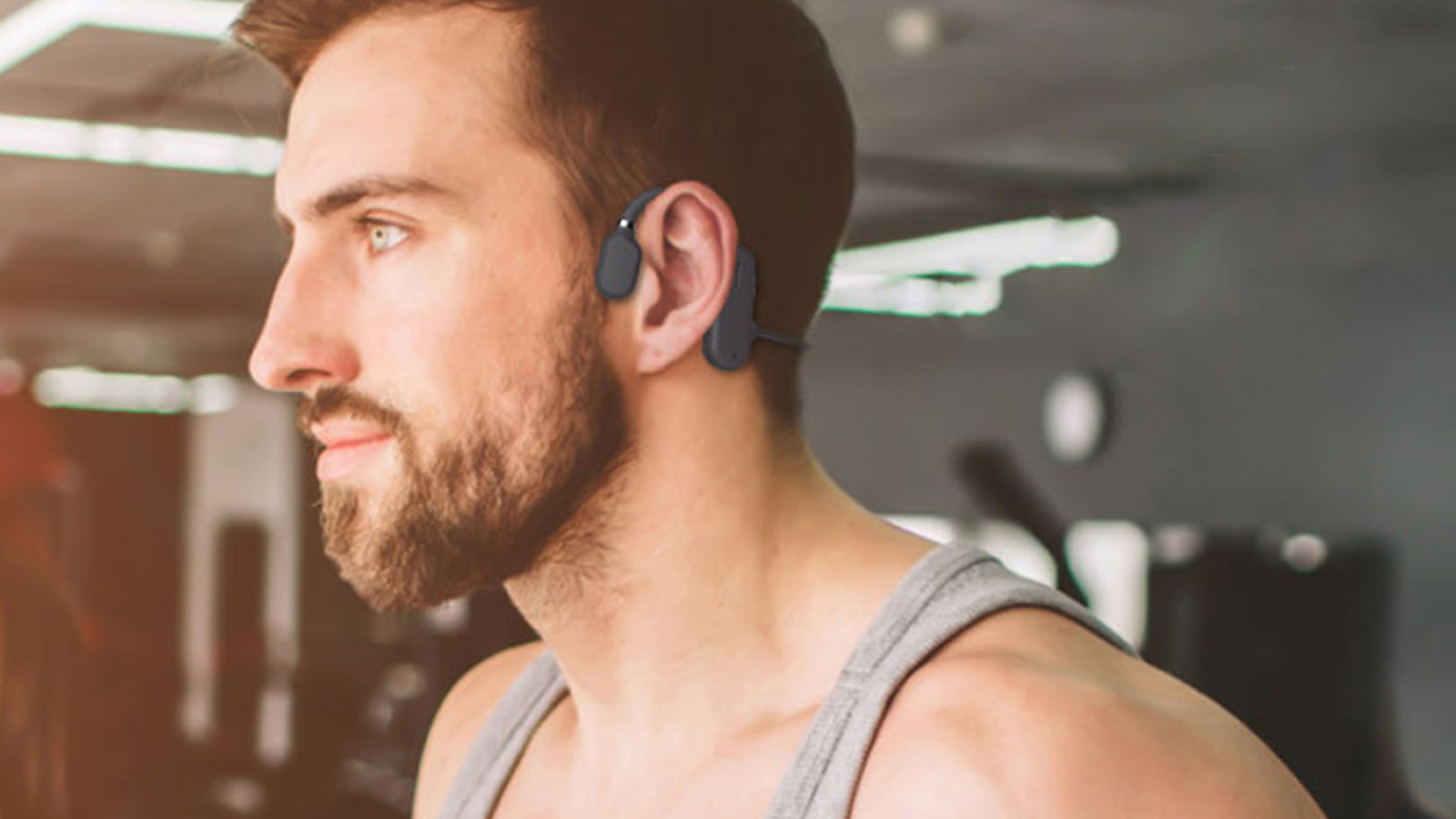 man wearing open ear headphones