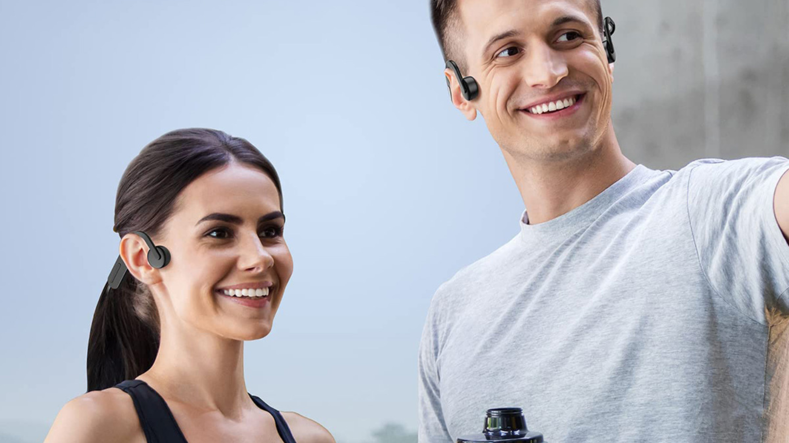 man and woman both wearing bone conduction headphones