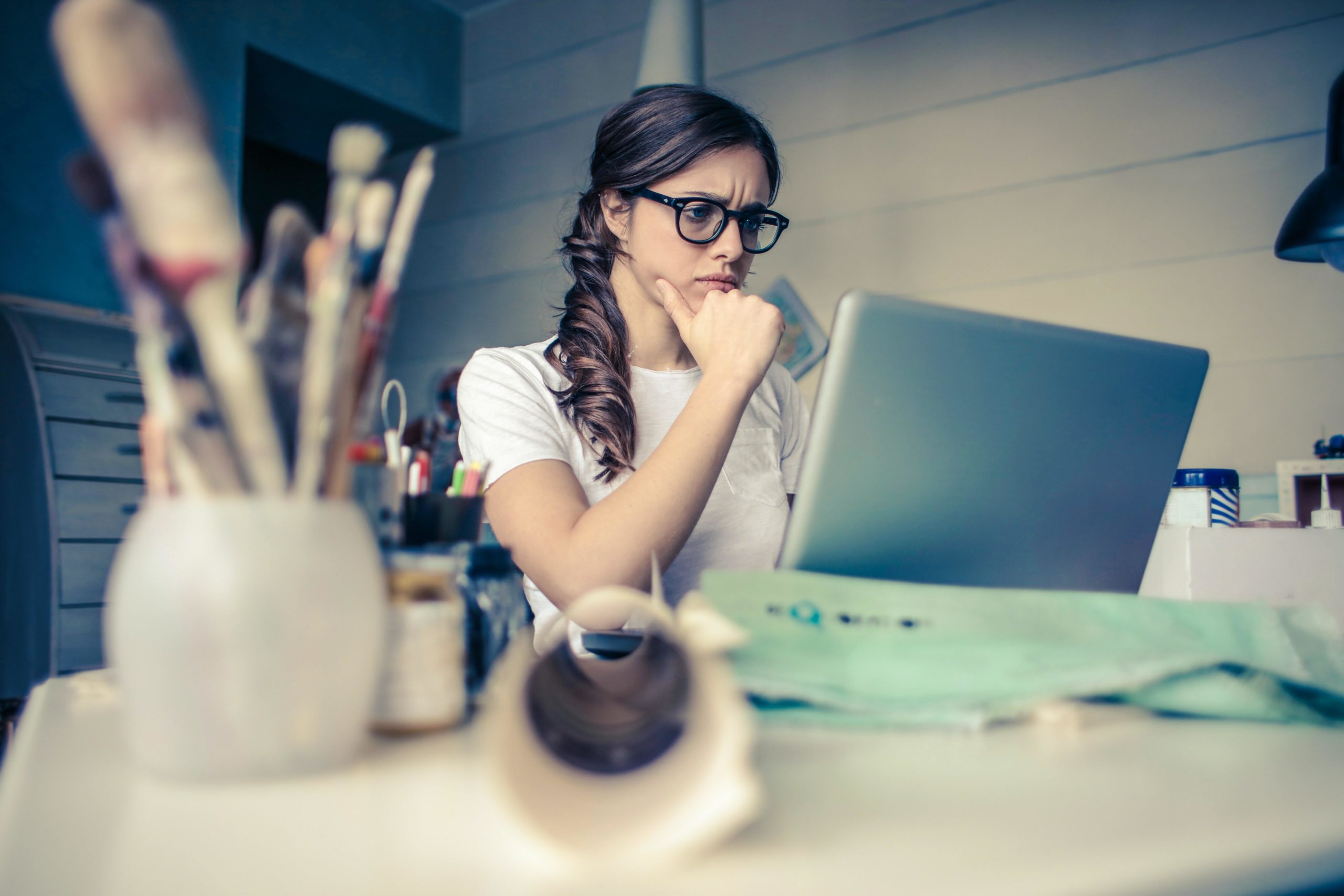 Girl looking puzzled at laptop