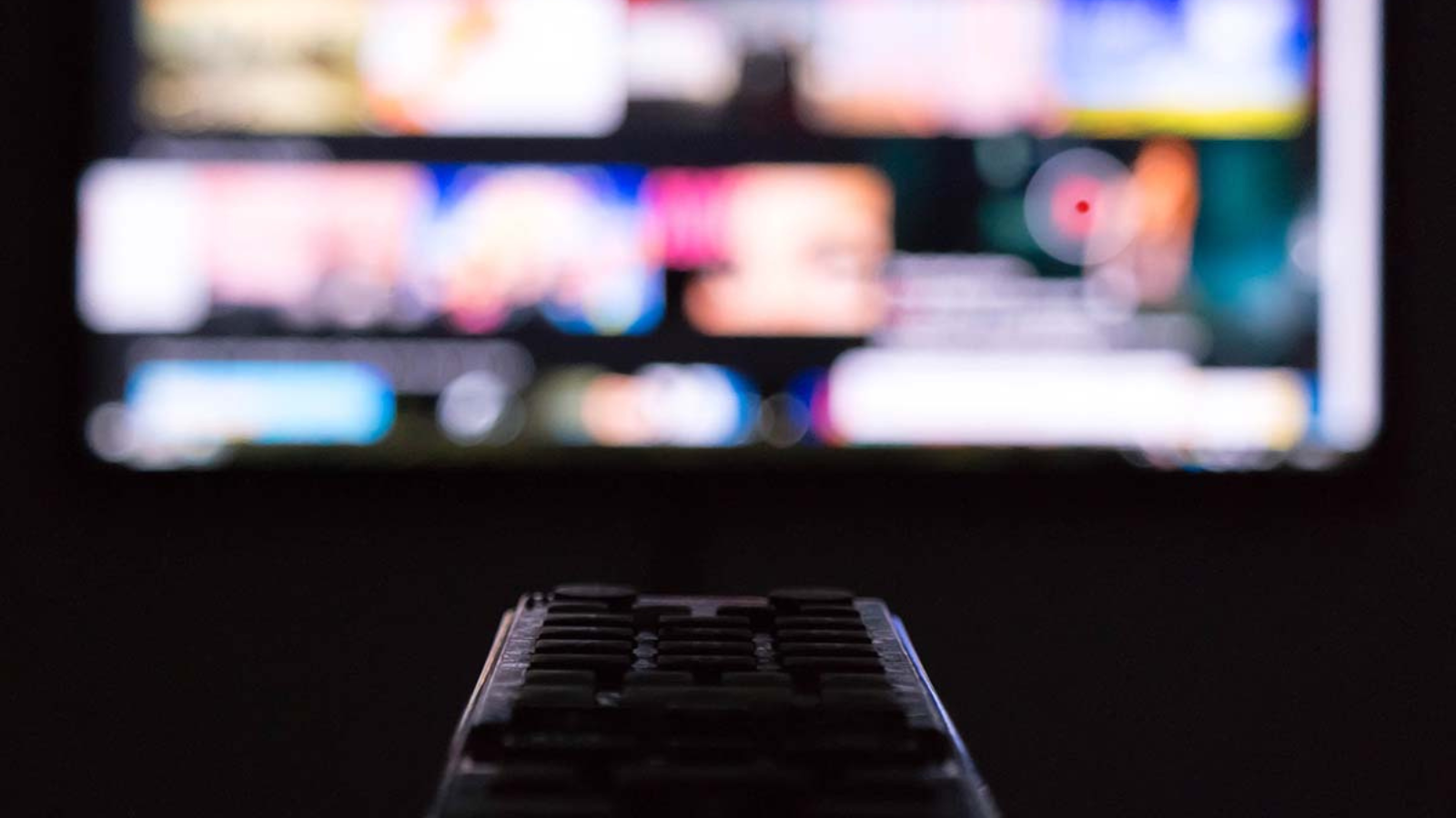 remote control pointing at tv blurred in background