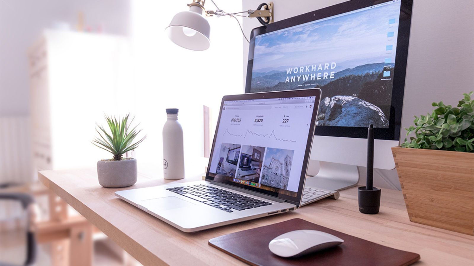laptop and monitor on desktop with ibrave hosting websites on screen