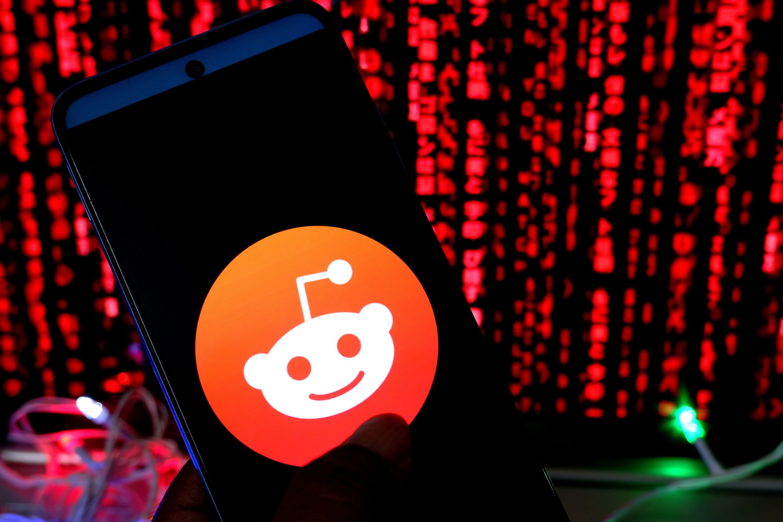 The Reddit logo on a phone