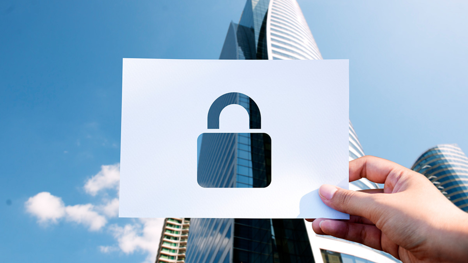 hand holding ilustrated lock over building