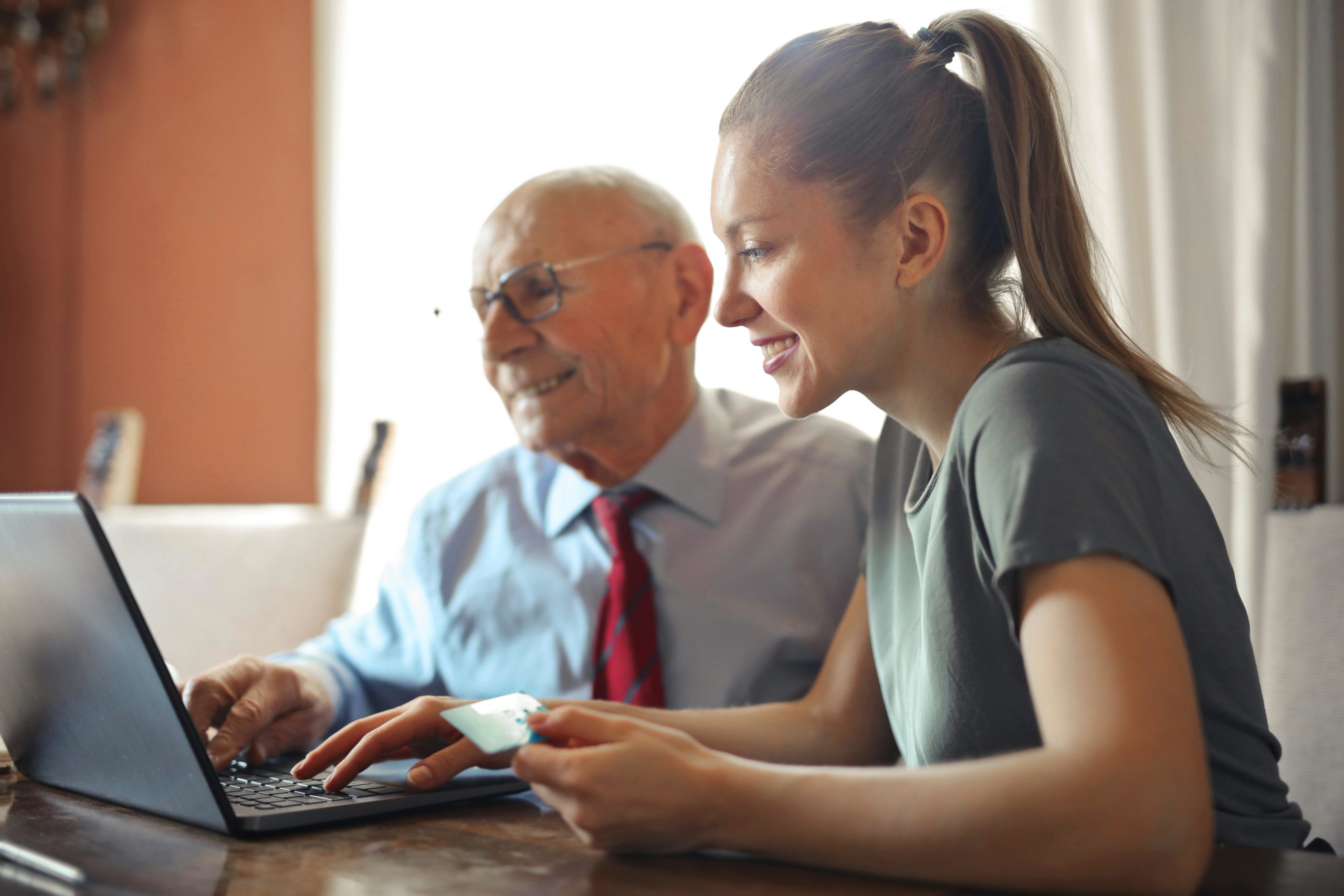 Girl and man looking at laptop