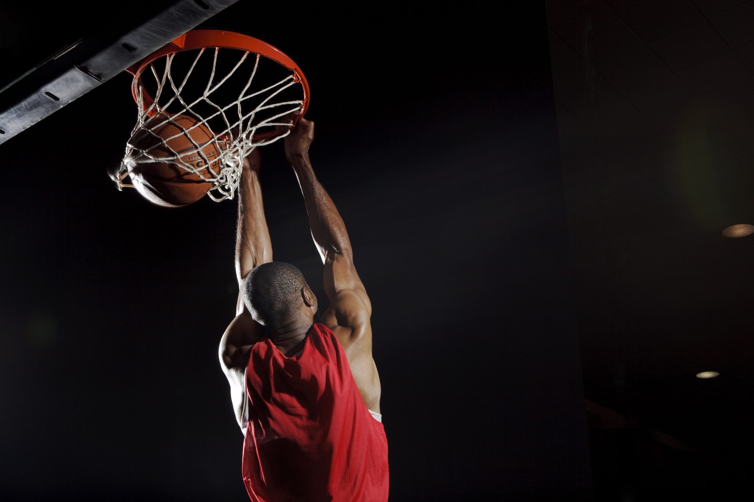 Man dunking basketball 