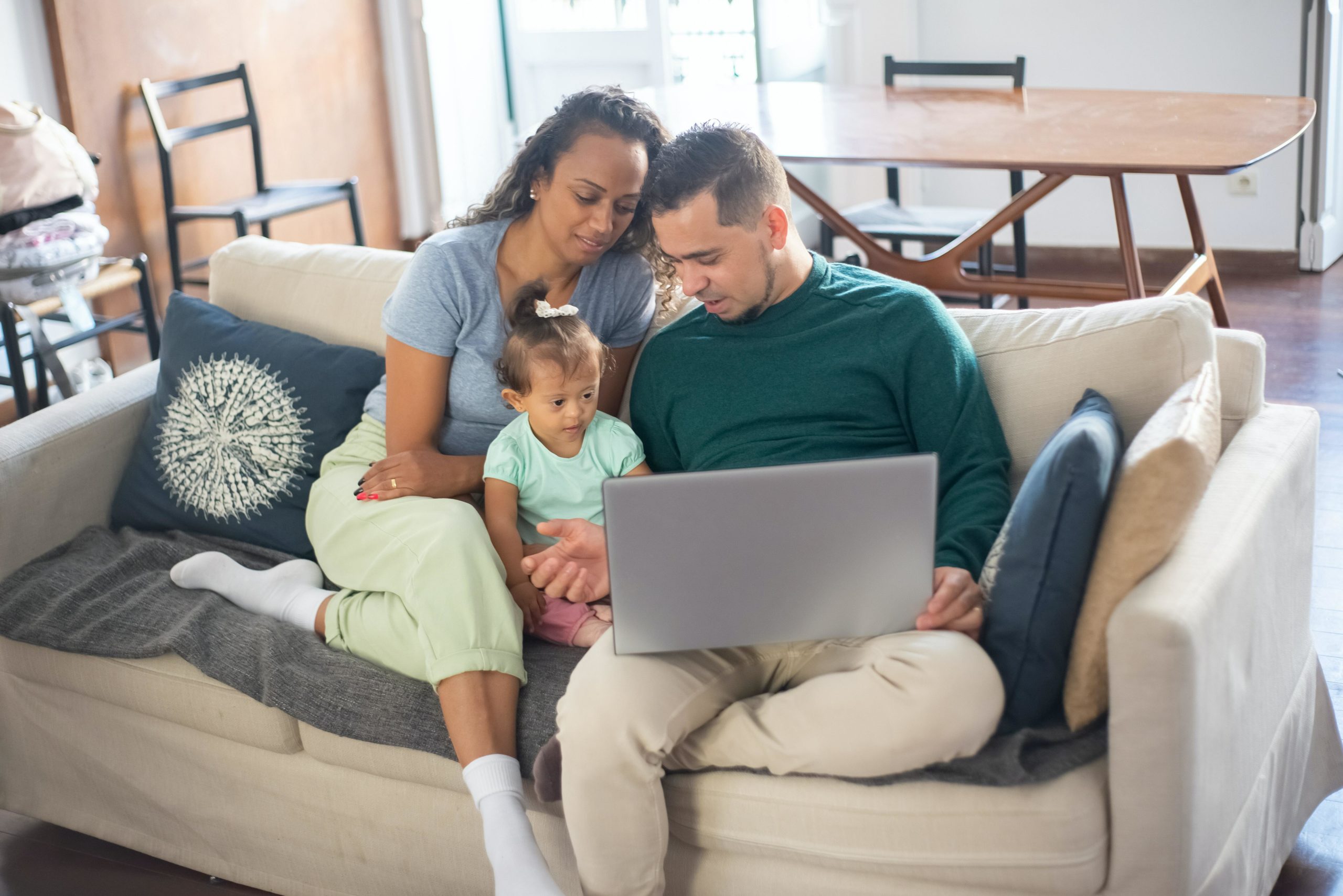 A family gathers around a computer.