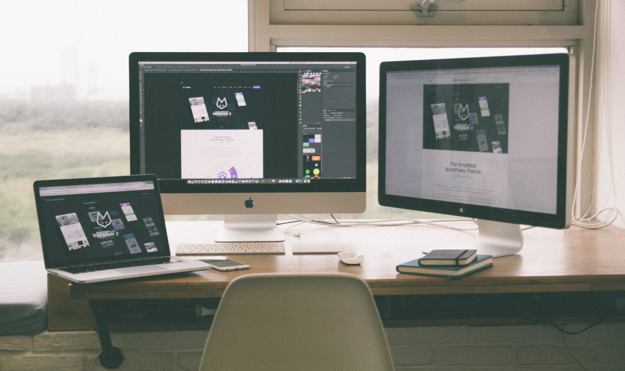 Three screens on desk