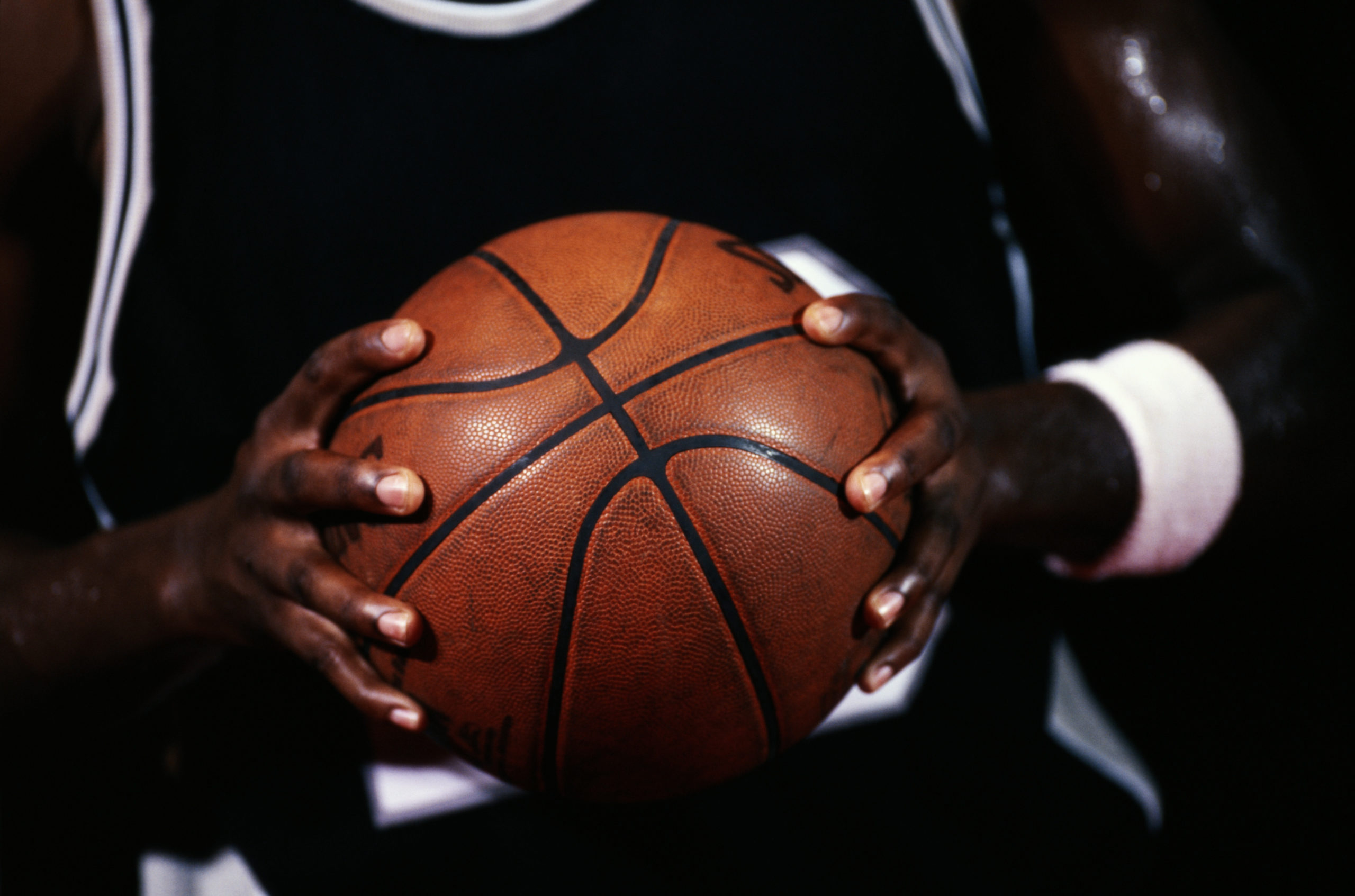 Basketball player gripping a ball