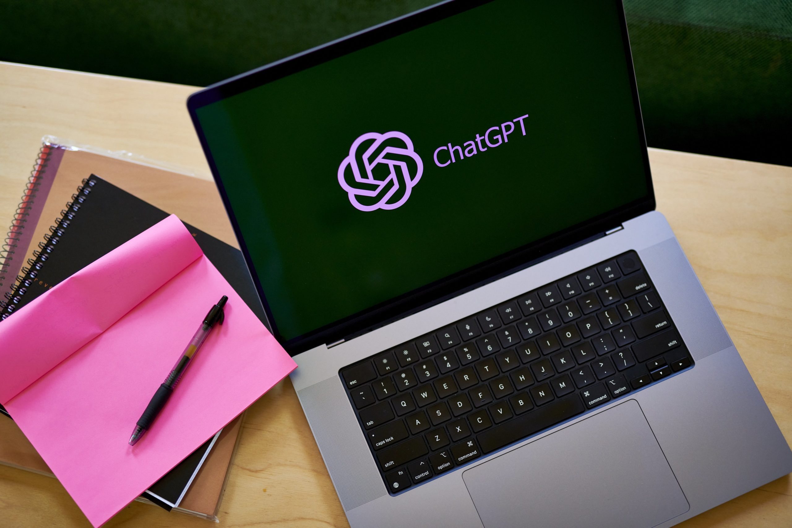 A notebook computer on a desk with the ChatGPT logo visible