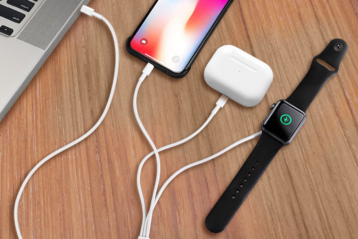 A phone, watch and headphones on a charging cable.