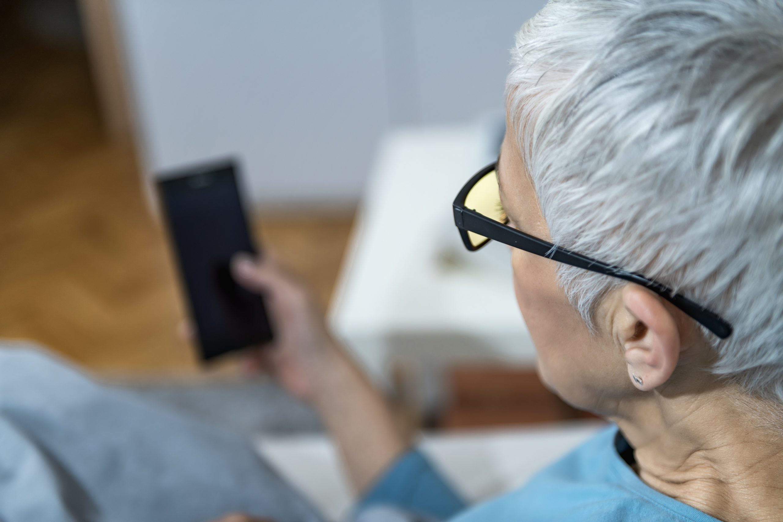 Mature woman wearing blue light blocking glasses 