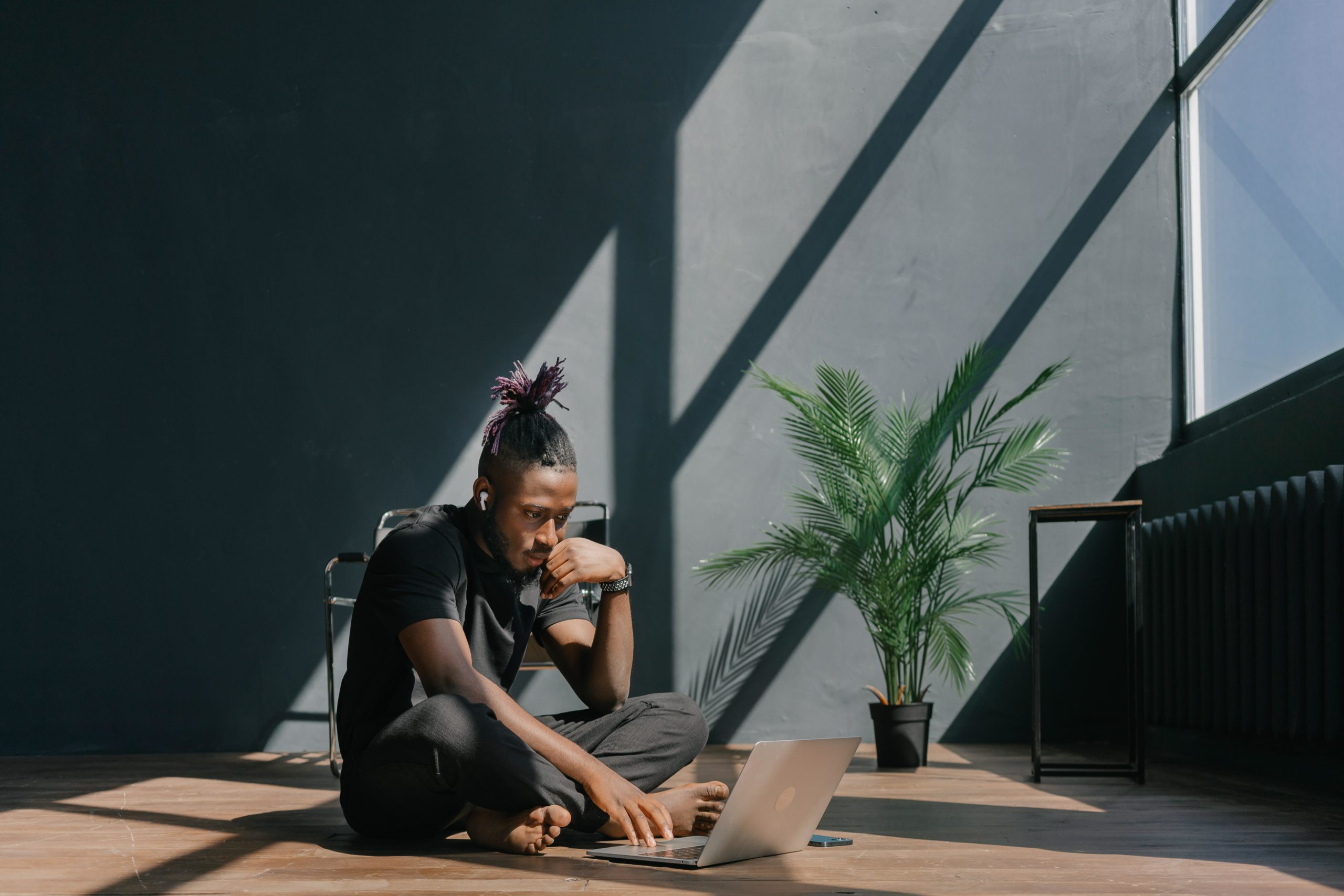 Man sat on floor with laptop