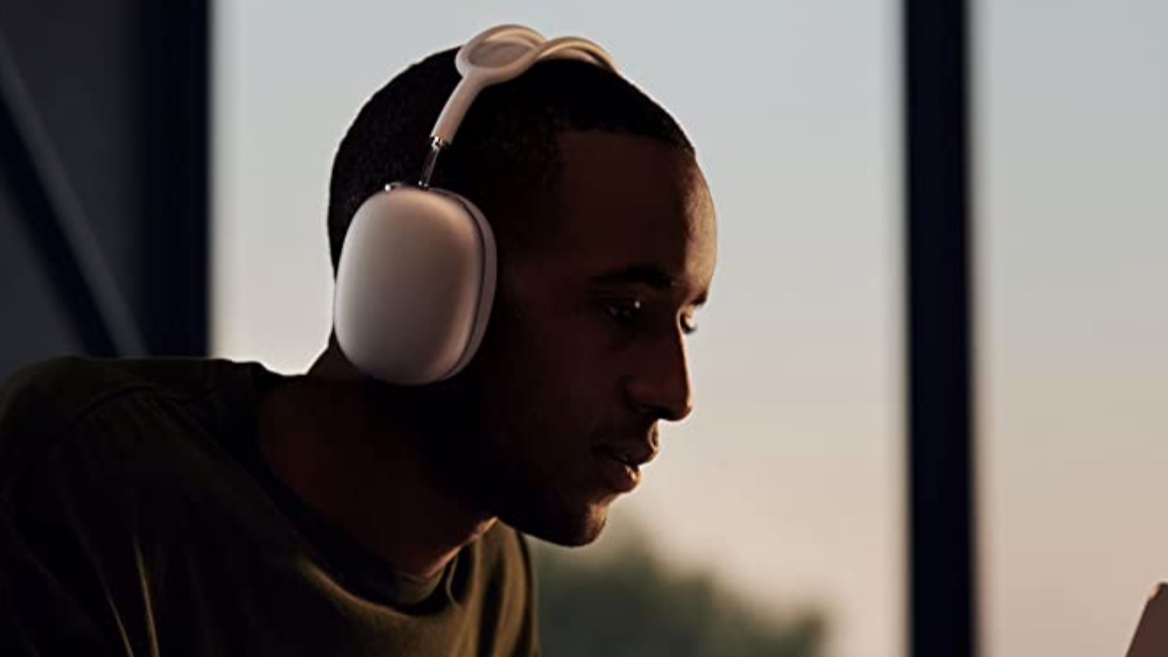Man with Apple AirPods Max at dusk