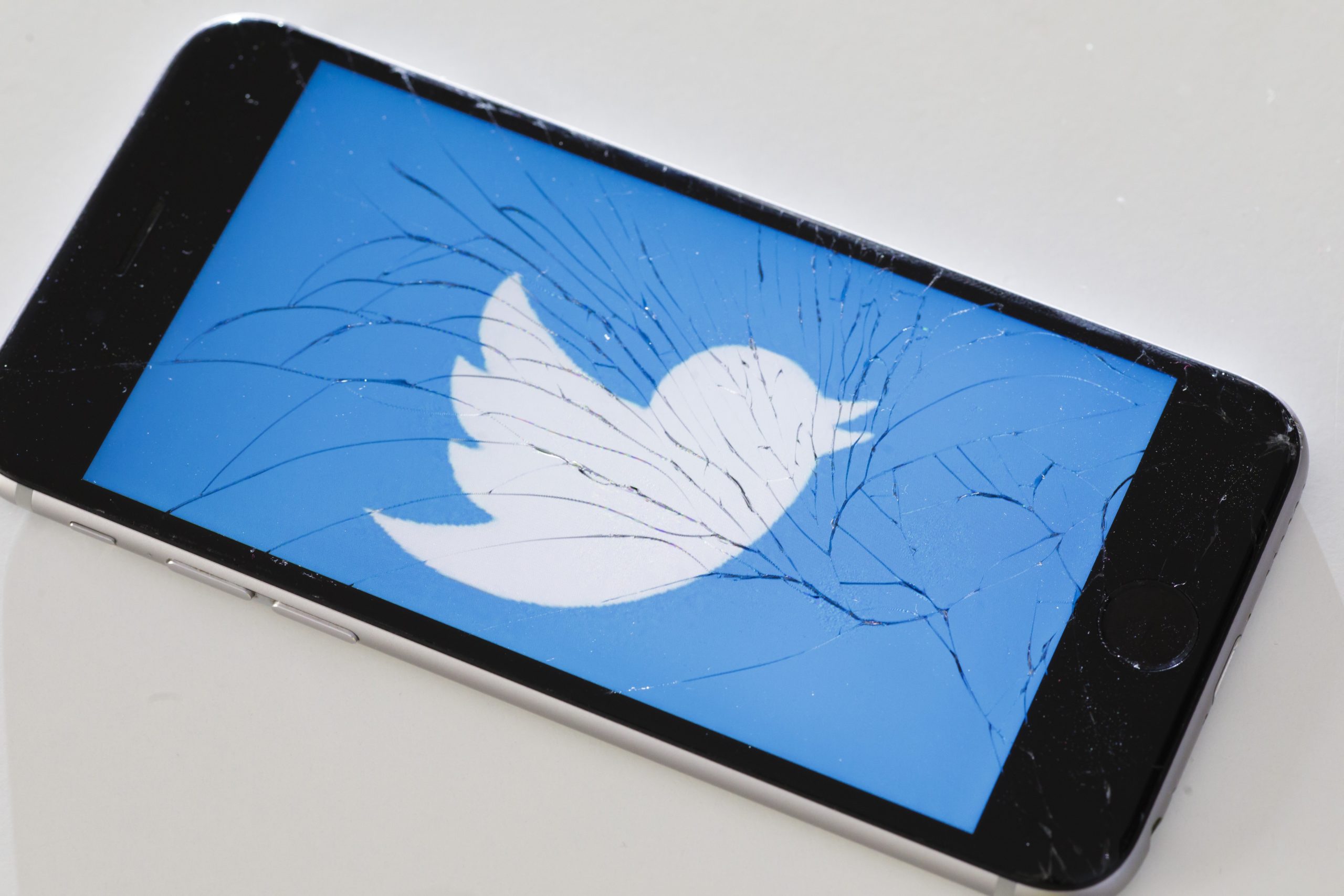 Twitter logo on broken iPhone screen