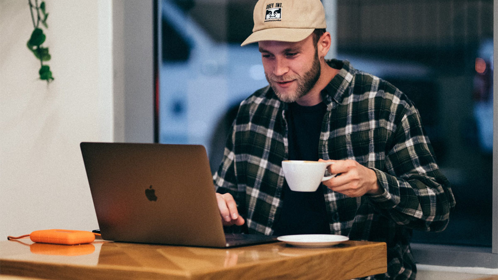 man drinking coffee and using laptop