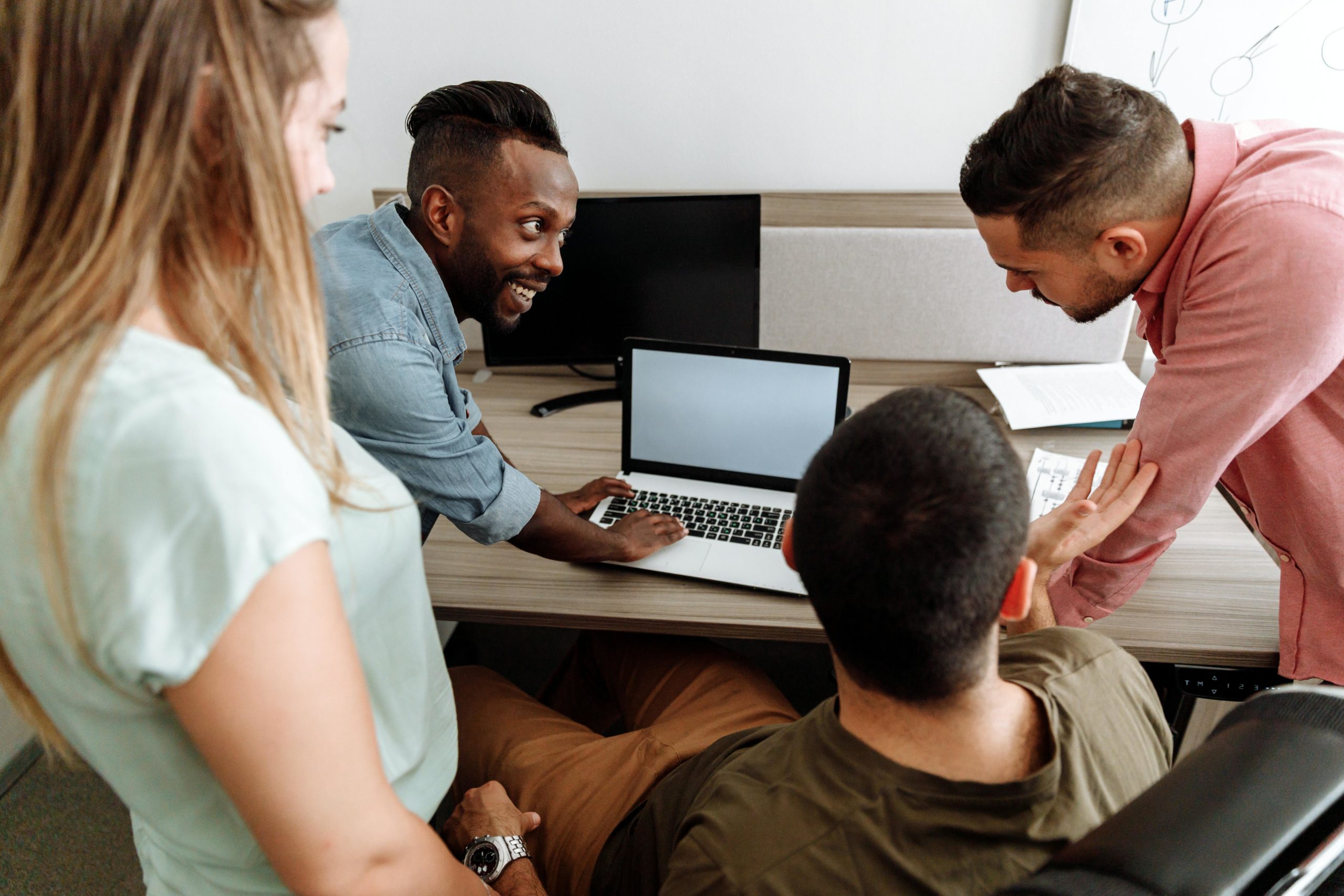 Group of people looking at laptop