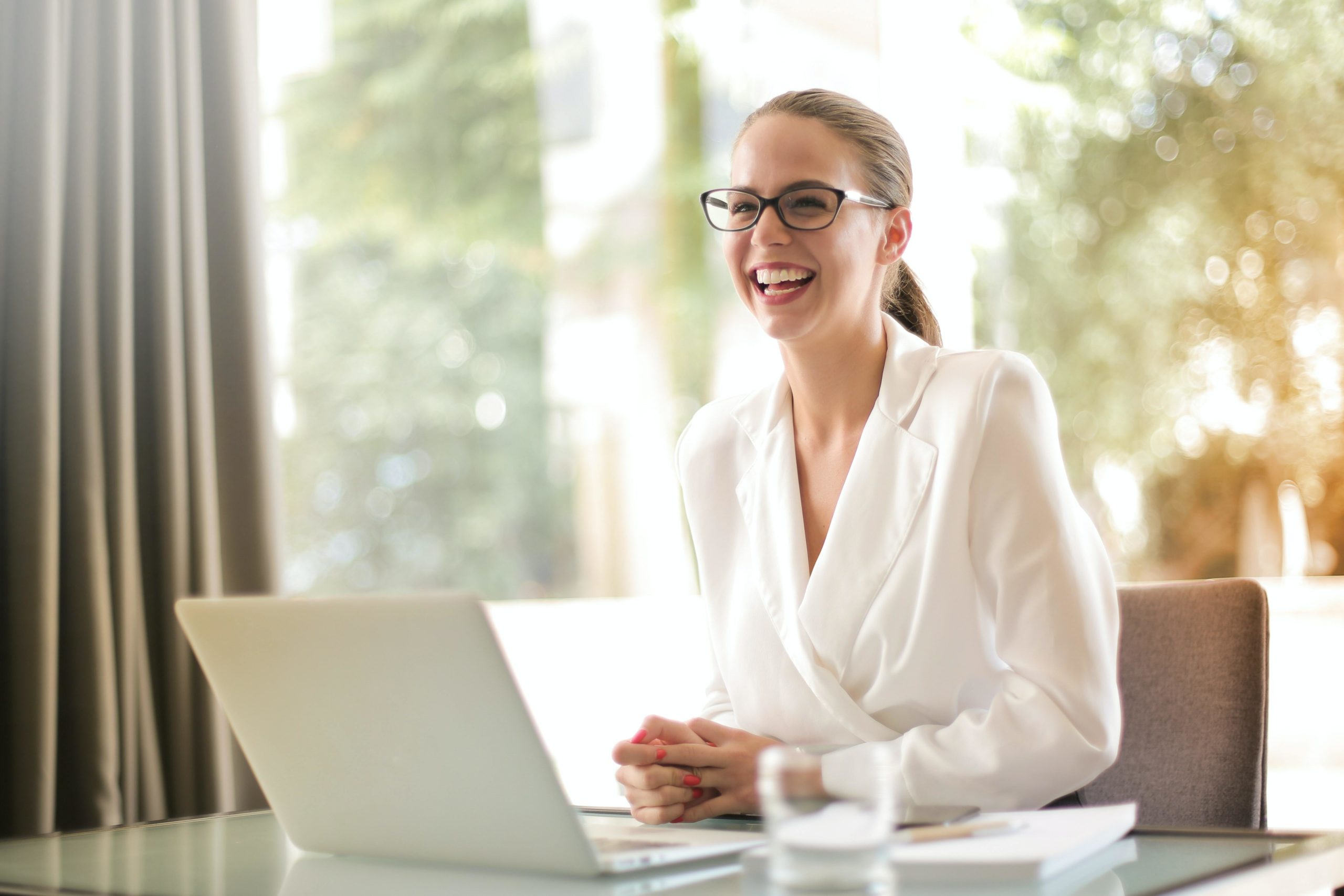 Woman smiling on her laptop.