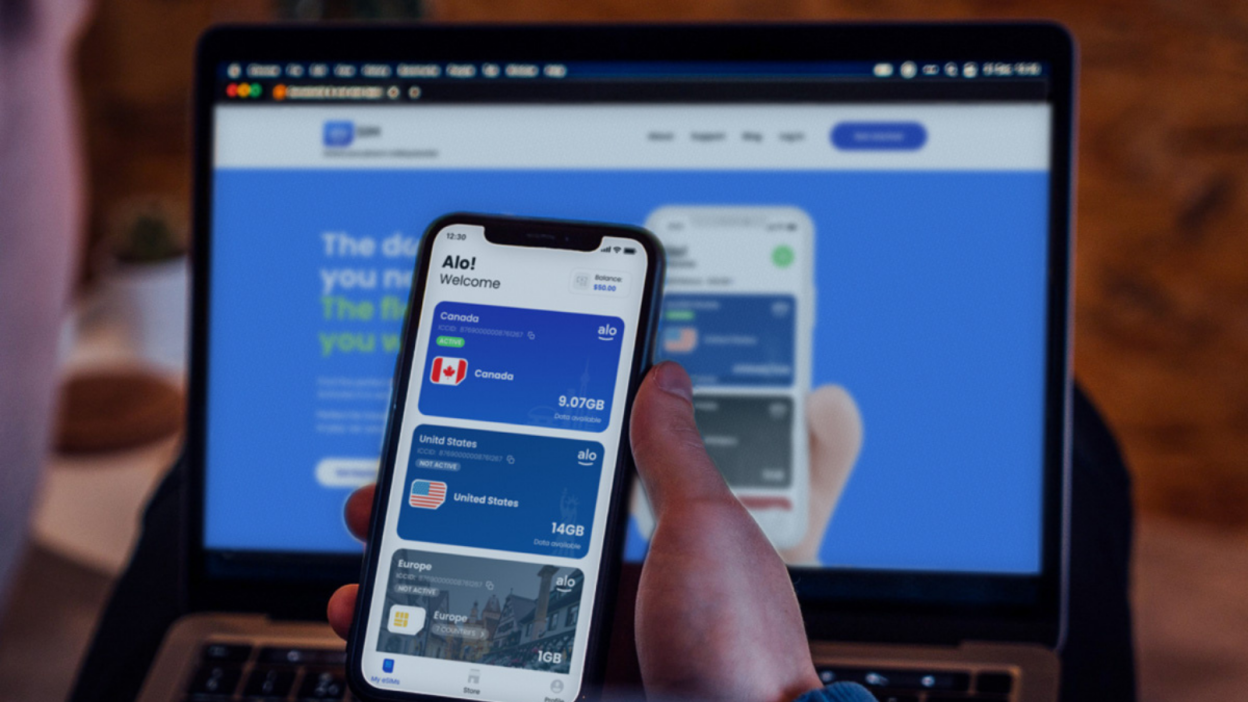 hand holding up phone with alosim app on screen