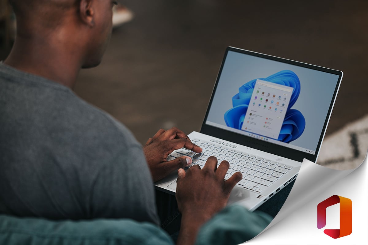 man using laptop with microsoft logo in corner