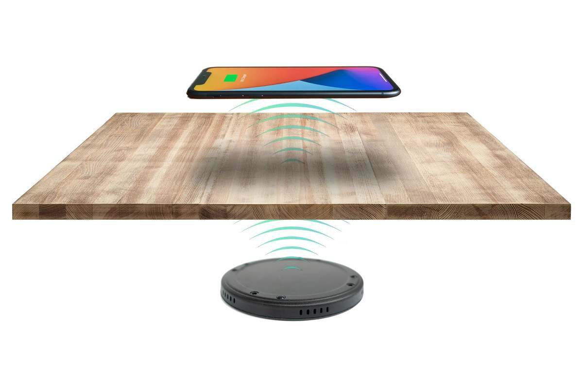 photograph of the wireless charger under a table with a phone pictured above the table