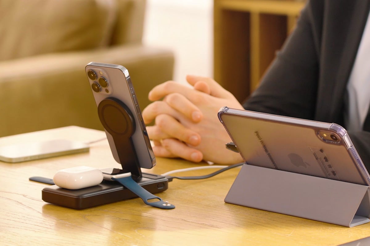 person sitting at desk using bellboy charging station for phone, apple watch, and airpods