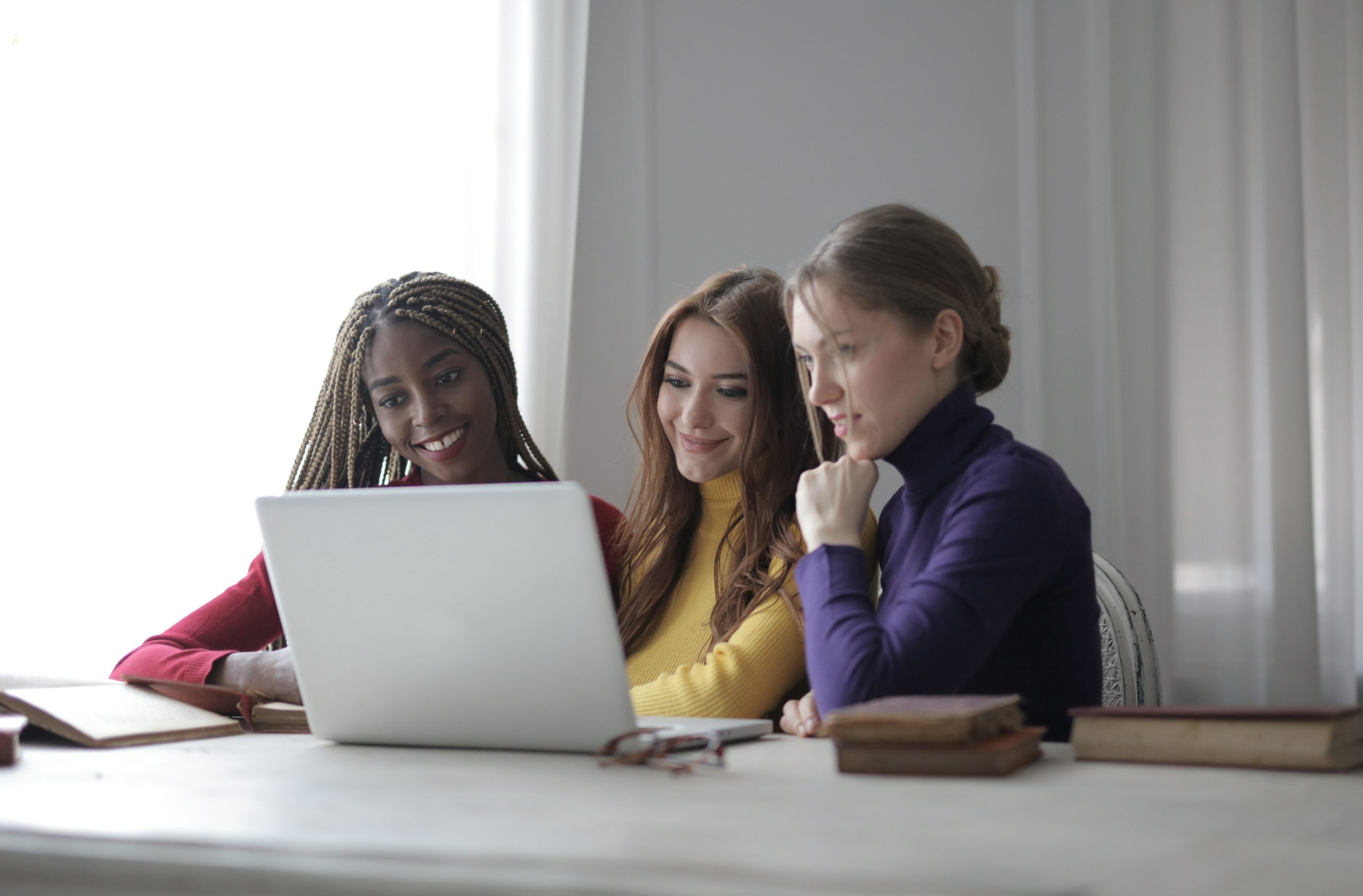 Three women looking at laptop