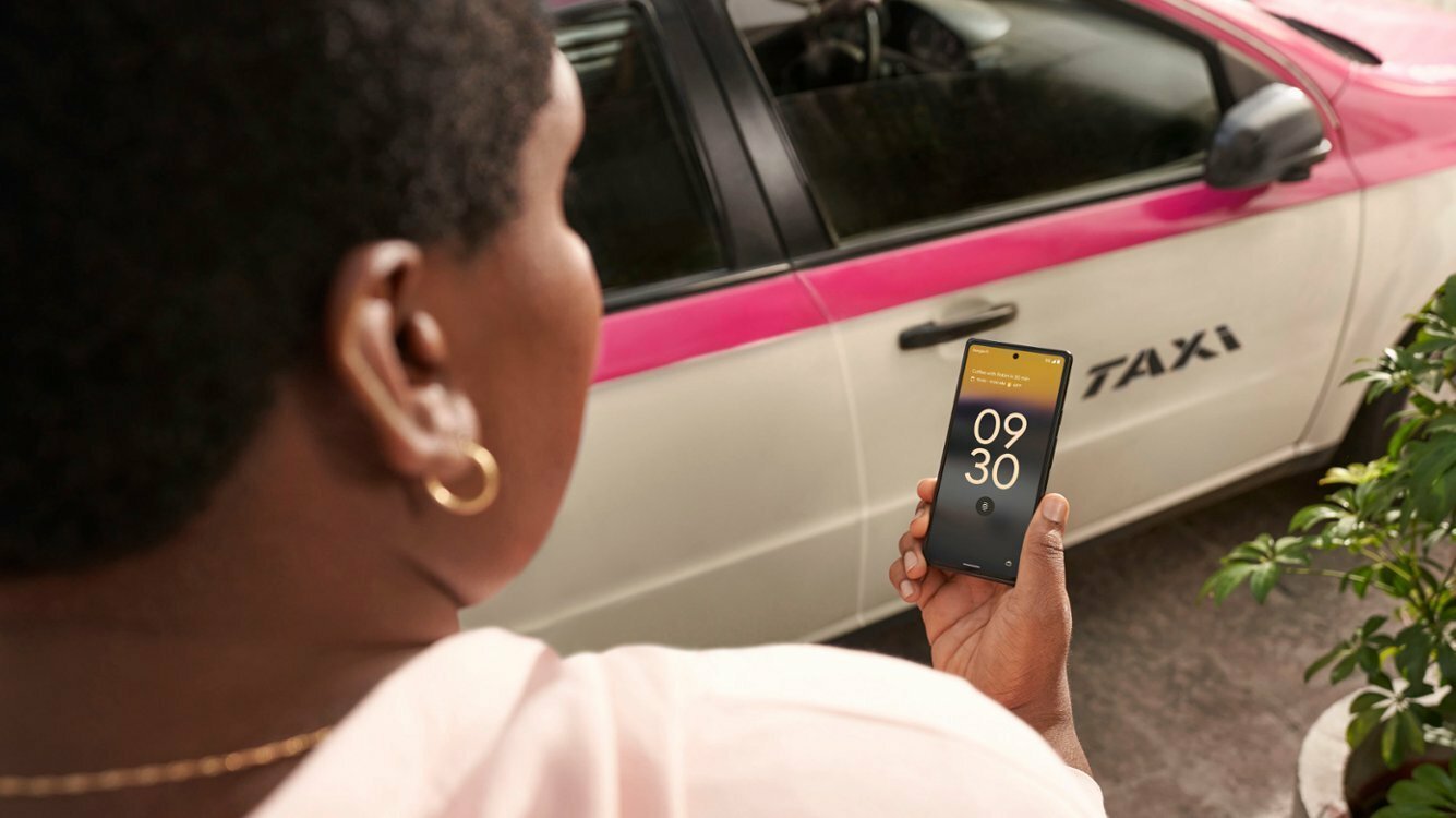 person looking down at charcoal google pixel 6a in their hand