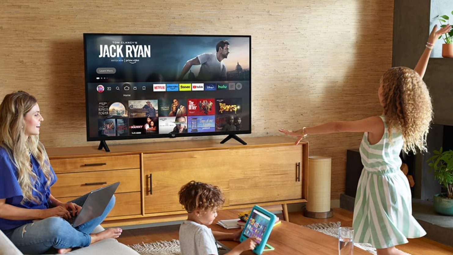 Woman and two children in a living room watching Jack Ryan on TV