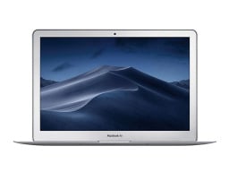 picture of a silver macbook air with screen open, screensaver shows photograph of a desert dune at night