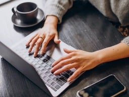 hands writing on a laptop